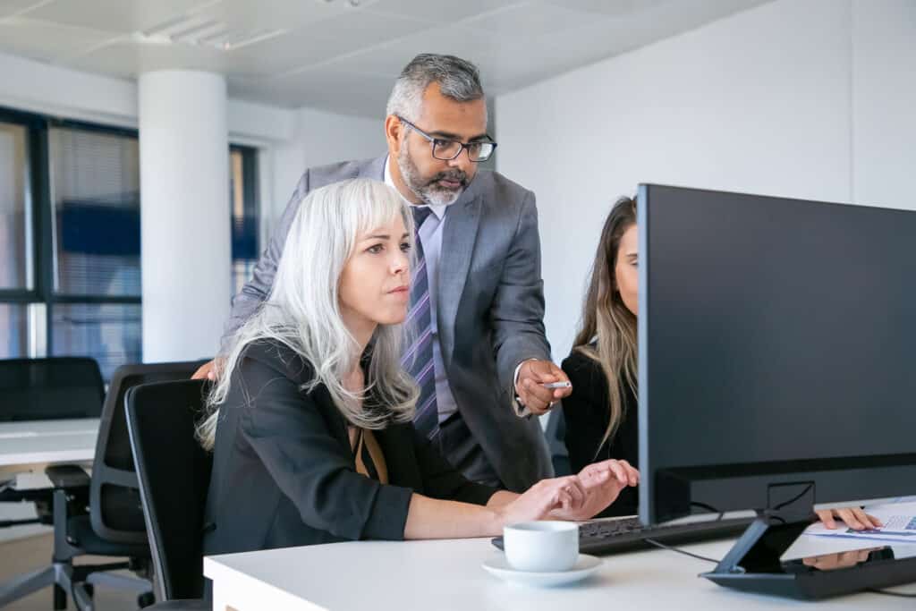 man and women at computer desk